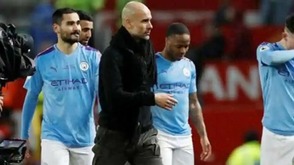 Manchester City manager Pep Guardiola and the Manchester City players look dejected after the match.