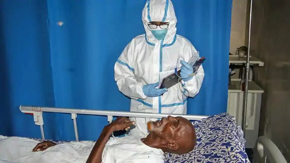 In this photo taken Wednesday, May, 13, 2020, a doctor tends to a patient in a ward for coronavirus patients at the Martini Hospital in Mogadishu, Somalia. Years of conflict, instability and poverty have left Somalia ill-equipped to handle a health crisis like the coronavirus pandemic.