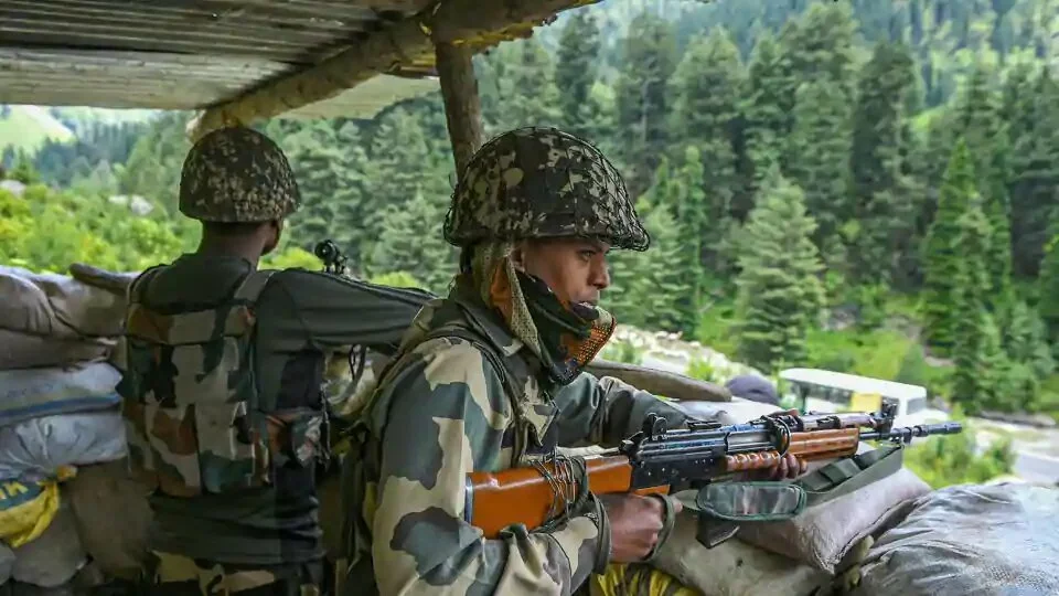 Border Security Force (BSF) personnel stand guard along the Srinagar-Leh National highway, in Ganderbal district of Central Kashmir.