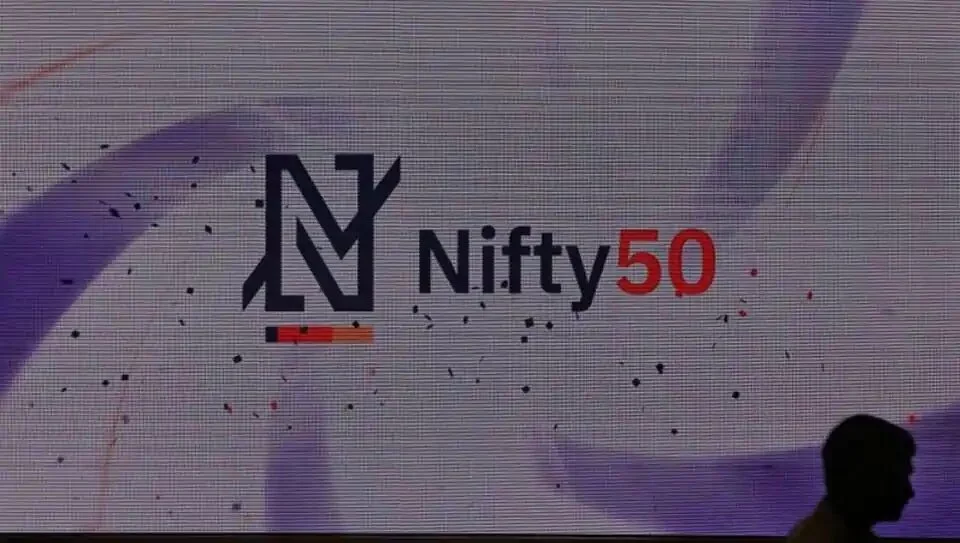 A man walks past a new brand identity for Nifty Indices inside the National Stock Exchange (NSE) building in Mumbai.